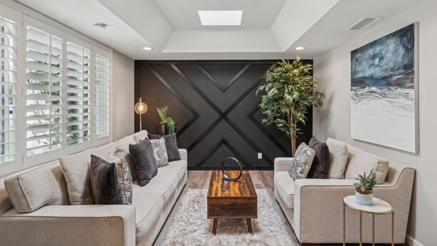 A modern living room with a sofa, coffee table, and decorative plants. - The Bridle is Right | Saltwater Pool | Backyard Games (Mesa)