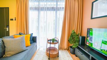 Premium Studio Suite | Living area | 45-inch Smart TV with digital channels, smart speakers