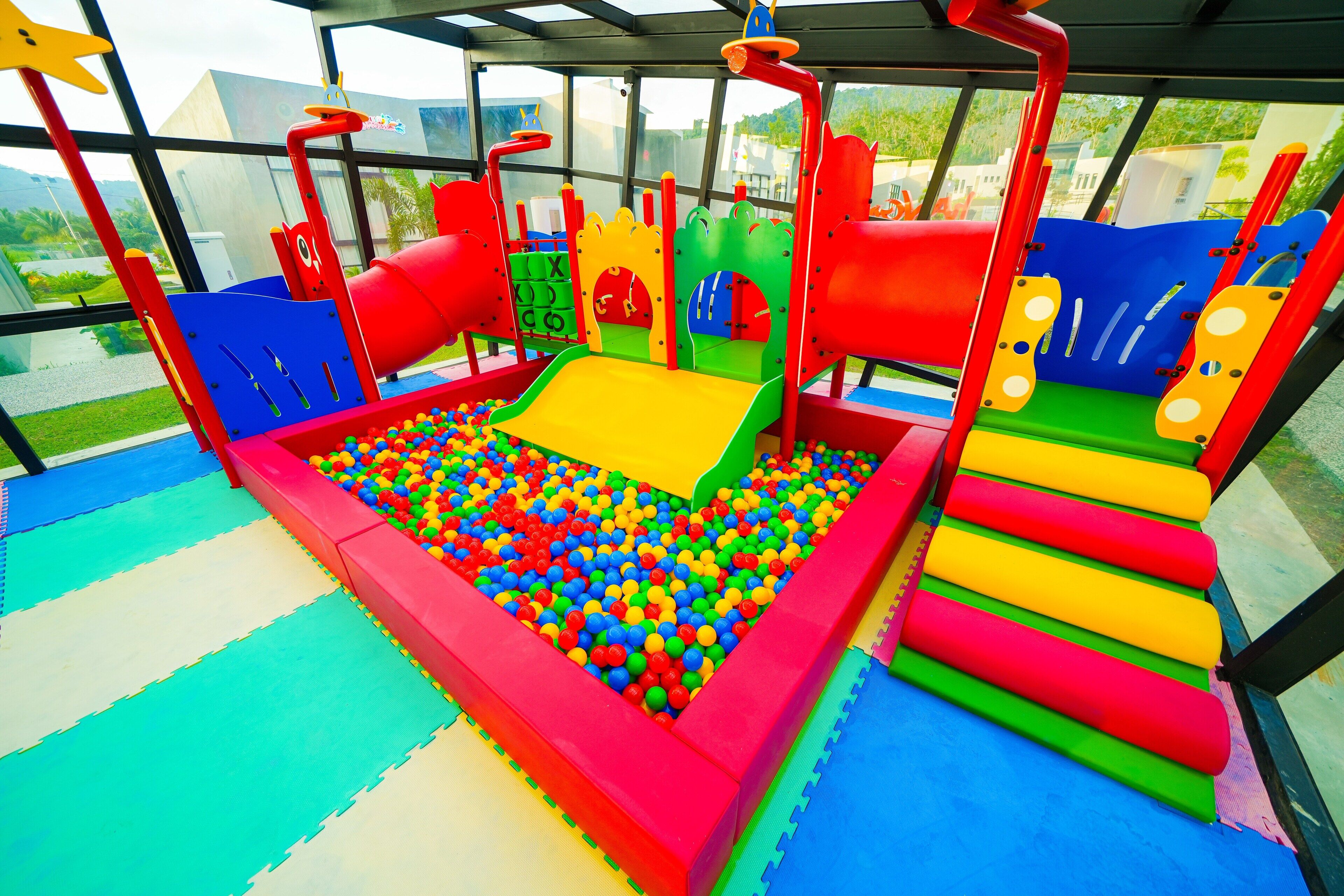 A children's play area with a ball pit and various play structures.