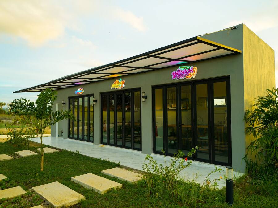 A modern building with a glass facade and signage for 'IndyKids'.