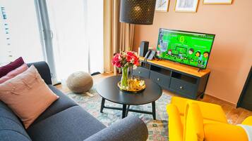 Family Suite | Living area | 45-inch Smart TV with digital channels, smart speakers