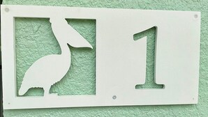 A white sign with a bird silhouette and the number 1. - Turtle Nest 1 - Quick Walk to Beach (Fort Myers Beach)