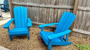 Two blue Adirondack chairs with a wooden fence in the background. - Turtle Nest 1 - Quick Walk to Beach (Fort Myers Beach)