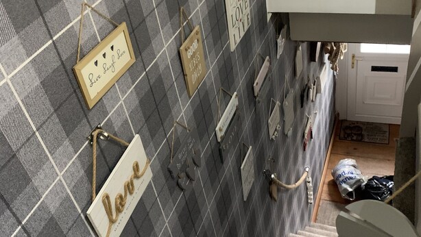 A staircase with a checkered wall and various inspirational signs. - Stunning 1-Bed Cottage in Halifax (Halifax)