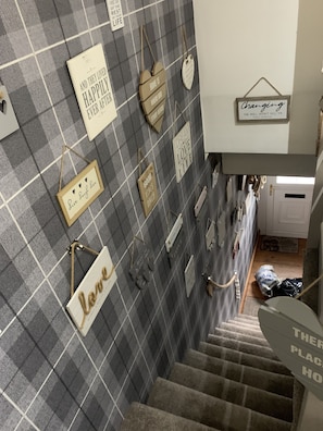 A staircase with a checkered wall and various inspirational signs. - Stunning 1-Bed Cottage in Halifax (Halifax)