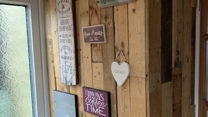 A wooden wall with various signs including 'WINE', 'La Cuisine', 'Bon Appetit', 'Always Coffee Time', and 'Kitchen'. - Stunning 1-Bed Cottage in Halifax (Halifax)