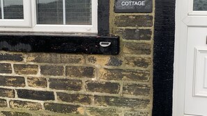 A stone cottage with a window and a door, labeled "28 HAYS COTTAGE". - Stunning 1-Bed Cottage in Halifax (Halifax)