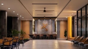 A spacious lobby with a reception desk, seating area, and a modern ceiling design. - Laska Hotel Resort Ciletuh (Girimukti)