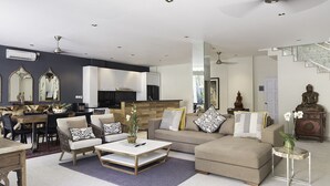 A modern living room with a sofa, coffee table, and dining area. - Villa Bebek Best Eat Street location in Seminyak,  (Seminyak)