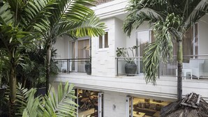 A modern multi-level residential building with balconies, large windows, and lush tropical plants. - Villa Bebek Best Eat Street location in Seminyak,  (Seminyak)