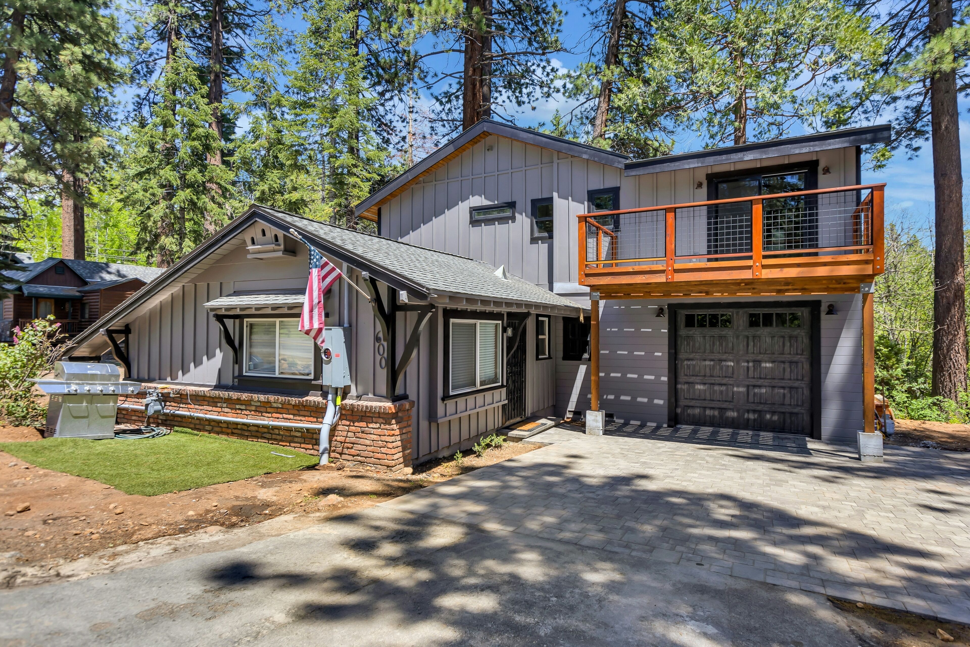Tree-lined modern hideaway with balconies, grill, games, gas fireplace, & W/D