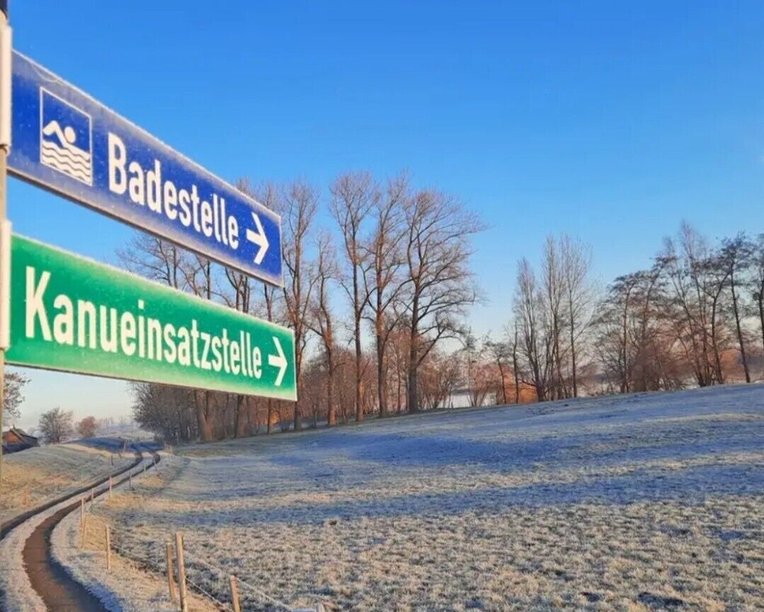 Directional signs for Badestelle and Kanueinsatzstelle.