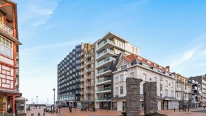 A multi-story building with a mix of residential and commercial spaces, including a pharmacy. - Sol i Mar - located in the heart of Westende (Middelkerke)