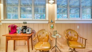 A room with two leather chairs, a wooden table with a coffee maker, and a small table with a lamp. - 5 Mi to Beach: Inglis Studio w/ Patio & Grill! (Inglis)