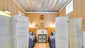 A room with two beds, a small table, and a ceiling fan. - 5 Mi to Beach: Inglis Studio w/ Patio & Grill! (Inglis)