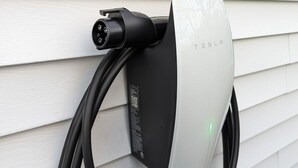 A Tesla charging station mounted on a white exterior wall. - The Rossie Studio · Near Mystic, Casinos + USCGA (Groton)