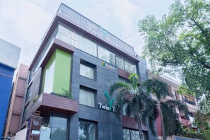 A modern hotel building with a sign for 'Twin Tree' and 'Treebo'. - Treebo Twin Tree (New Delhi)