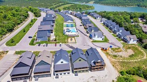 A residential area with houses, a swimming pool, and a road.