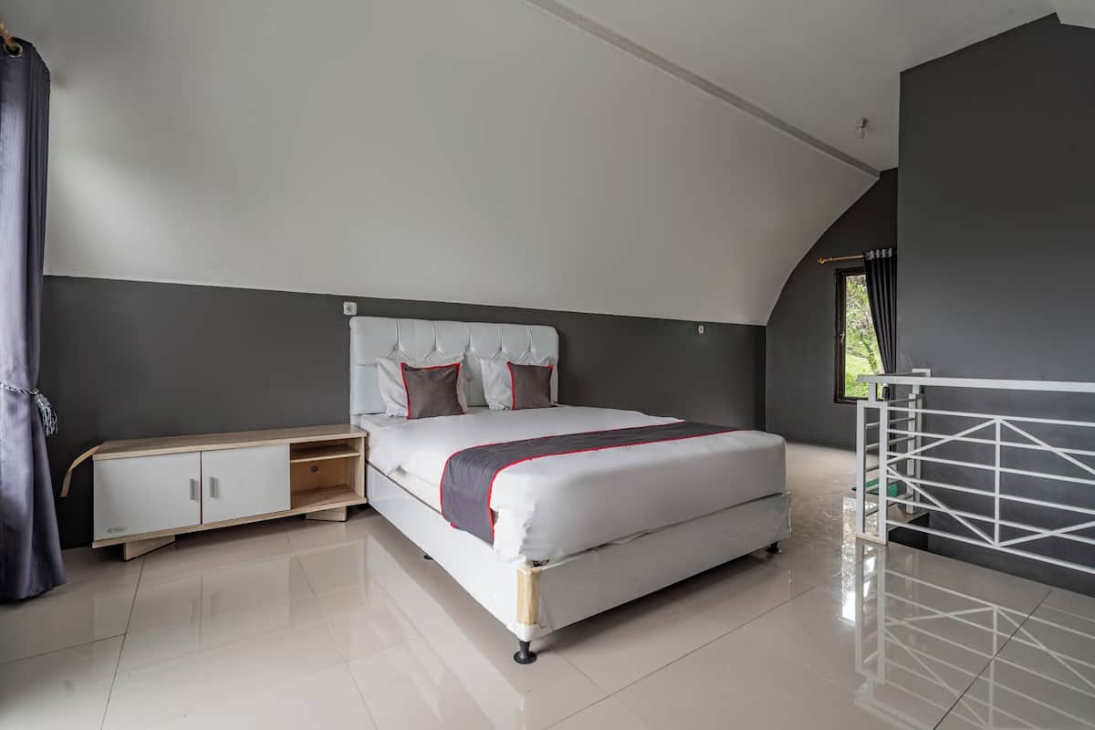A modern bedroom with a bed, a nightstand, a wardrobe, and a window with curtains.