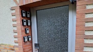A door with a security keypad and a metal detector.