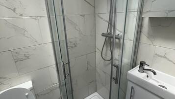 Shower, hair dryer, towels, toilet paper