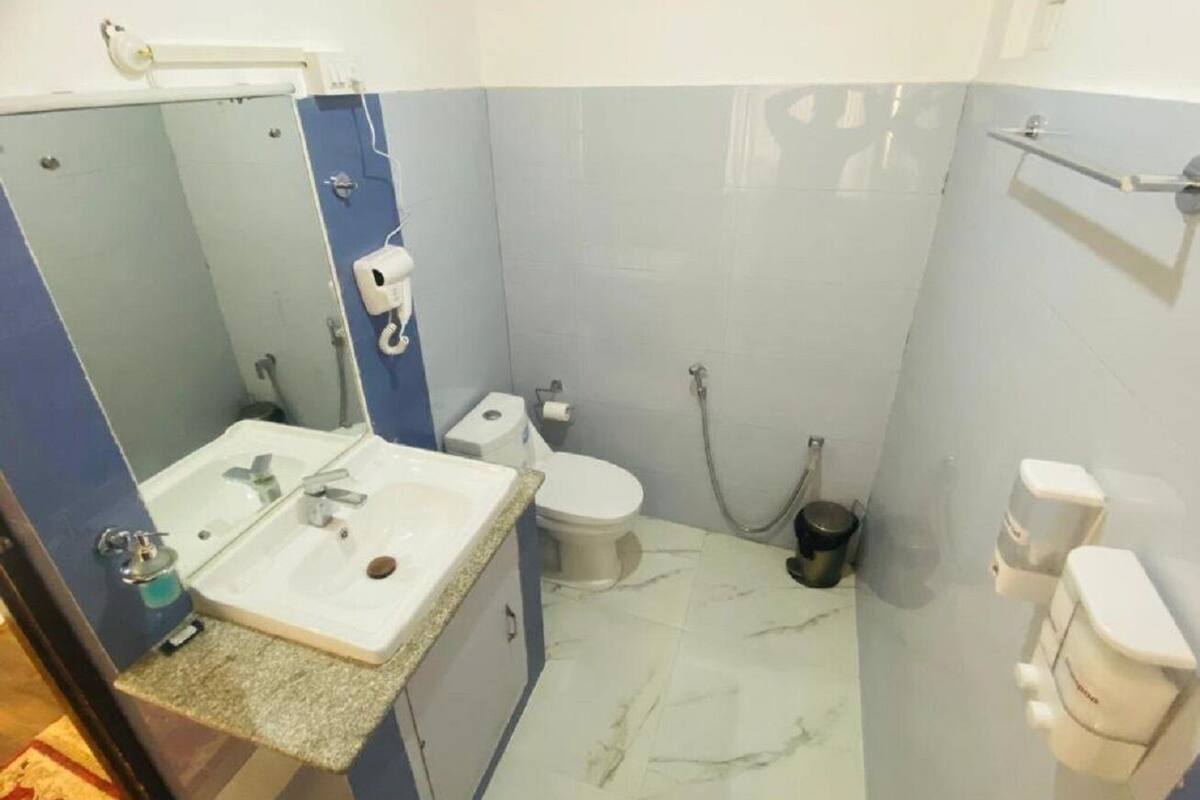 A bathroom with a sink, toilet, and shower.
