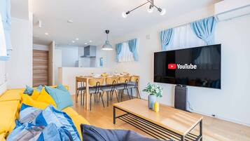 Executive House | Living area | 50-inch flat-screen TV with cable channels