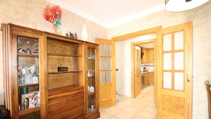 A spacious kitchen with wooden cabinets and a tiled floor. - 1020 Casa Pat (Nerja)