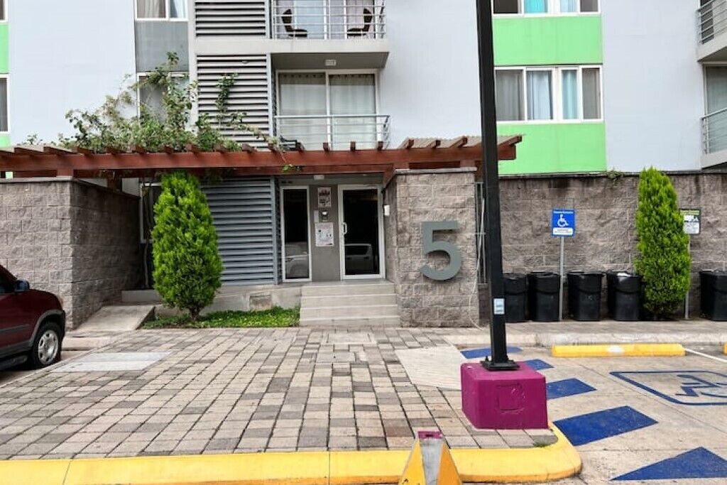 An entrance to a building with a stone facade, a numbered entrance, and a disabled parking sign.