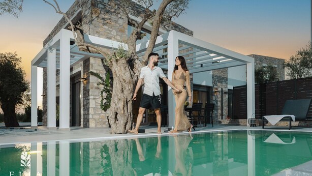 A modern villa with a swimming pool, stone architecture, and a pergola structure. - Deluxe Private Pool Villa, Elia Stone Villas (Thasos)