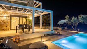 A modern villa with a stone exterior, outdoor seating area, and a swimming pool. - Premium Private Pool Villa, Elia Stone Villas (Thasos)