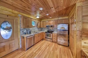 Kitchen features an oven, microwave, and refrigerator.
