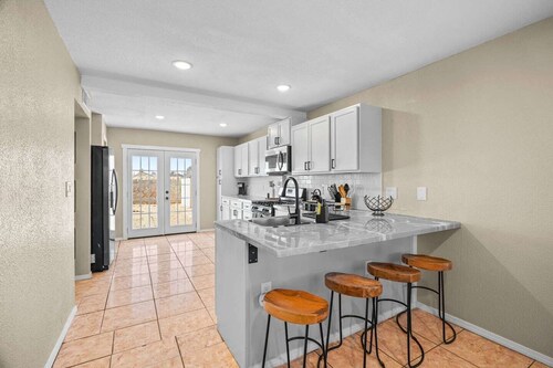 Spacious 2-story contemporary home perfect for families or professionals. Features a dedicated office, fully equipped kitchen, and a rare king bed in the primary suite. Comfortably accommodates your group with multiple stylish bedrooms.
