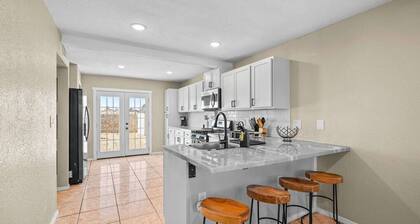 Spacious 2-story contemporary home perfect for families or professionals. Features a dedicated office, fully equipped kitchen, and a rare king bed in the primary suite. Comfortably accommodates your group with multiple stylish bedrooms.