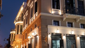 A row of historic buildings with classic architecture, including balconies and ornate doorways. - Living Yard Thissio (Athens)