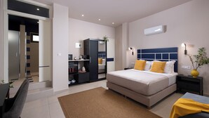 A modern bedroom with a bed, bedside tables, a desk, and a wardrobe. - Living Yard Thissio (Athens)
