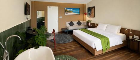 A hotel room with a bed, a desk, a chair, a sink, and a bathtub.
