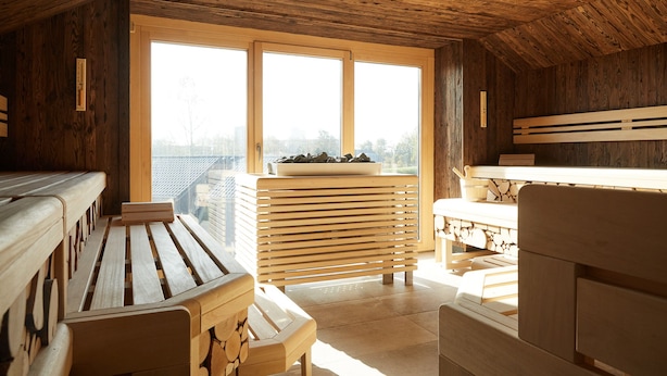 A wooden interior with a bench, a table, and a window with a view of the outside.