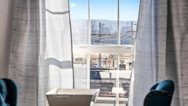 Une chambre d’hôtel avec vue sur le paysage urbain, grâce à de grandes fenêtres.