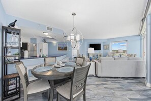 A modern interior with a dining area, kitchen, and living space.