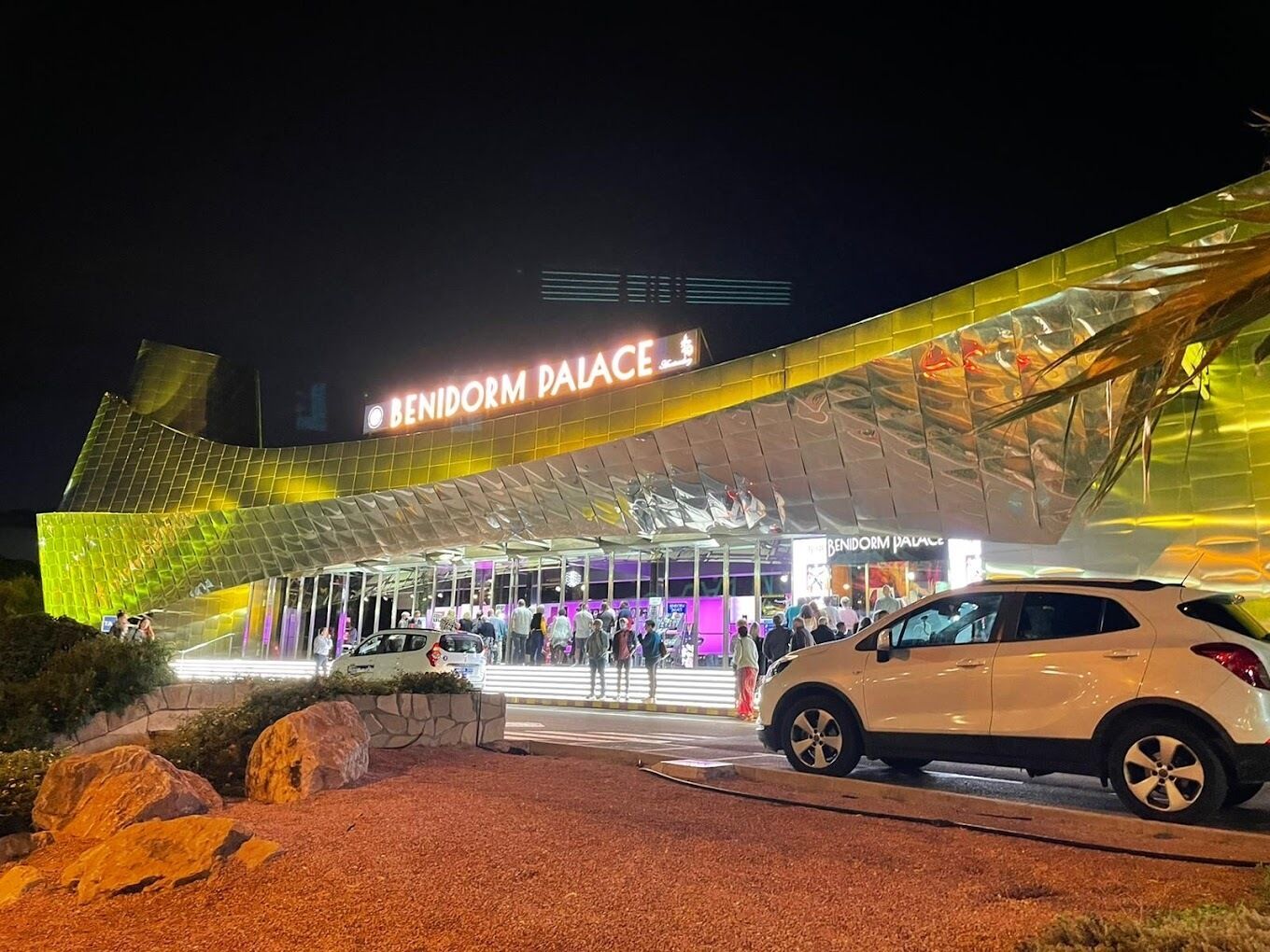 A modern building with a curved roof and a large entrance.