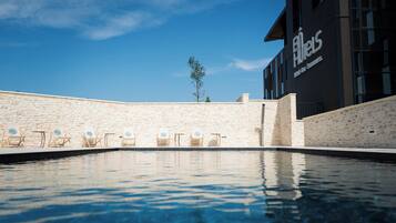 Seasonal outdoor pool, open 10:30 AM to 10:00 PM, pool umbrellas