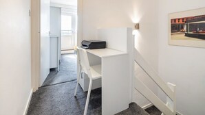 A hallway with a white desk, a printer, and a framed picture on the wall. - Wandsworth Retreat: Spacious Quiet 2BR 2Bth Duplex + View + Nr Trains To Center! (London)