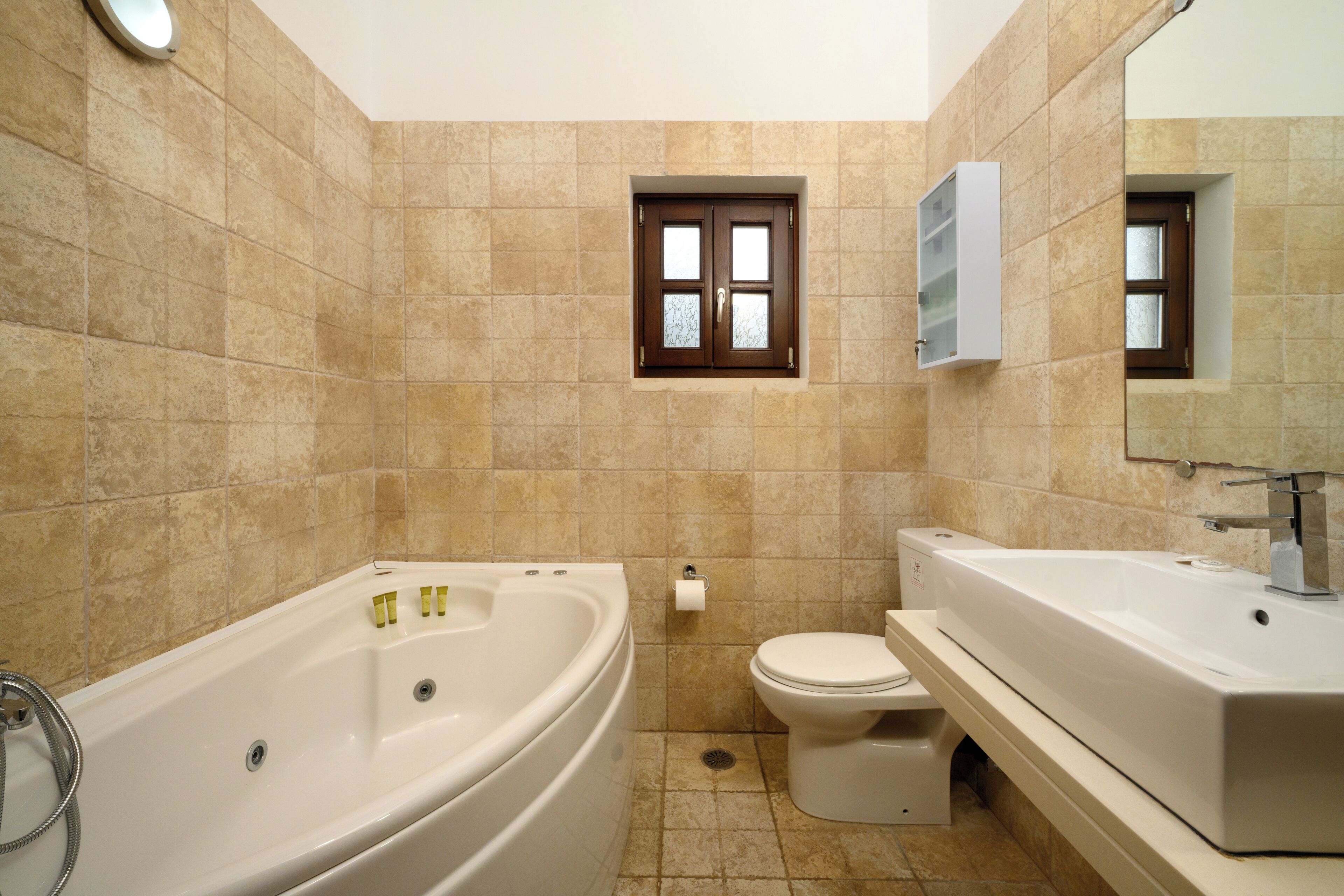 A bathroom with a bathtub, toilet, and sink.