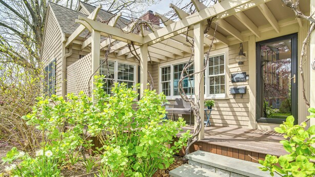 A house with a covered porch, a front door, and a small garden area with plants and steps leading up to the entrance. - Expansive Group Getaway < 1 Mi to Dtwn Falmouth! (Falmouth)