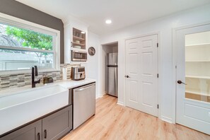 A modern kitchen with a built-in dishwasher, a microwave, a coffee maker, and a refrigerator. - Walk to Parks & Dining! San Antonio Getaway (San Antonio)