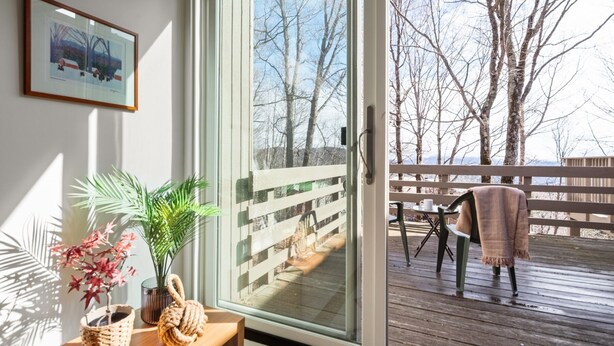 A room with a sliding glass door leading to an outdoor deck. - 22 Village Run 3 Bedroom Condo by RedAwning (Warren)