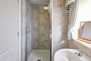 A bathroom with a shower, a sink, and a mirror. - Host Stay Grange Cottage (Belford)