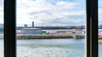 A waterfront industrial area with large buildings and a dock.