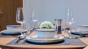 A dining table set with plates, bowls, glasses, and cutlery. - Host Apartments The Georgian Quarters at Canning (Liverpool)